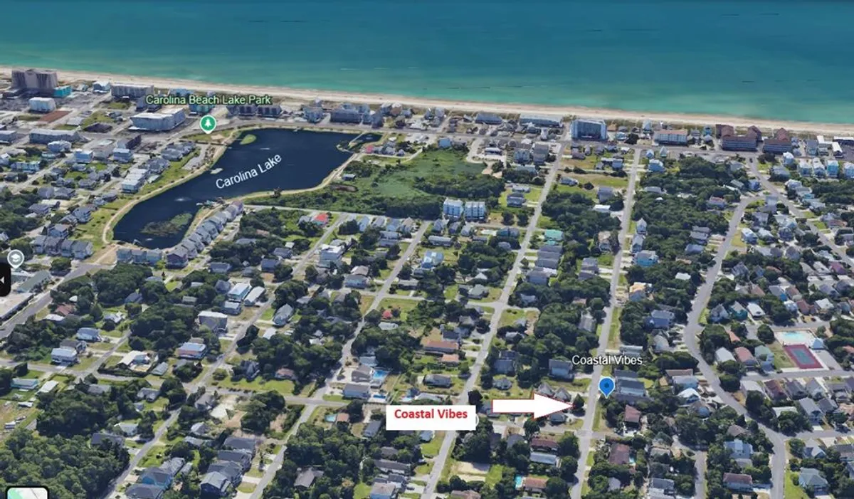 A scenic view of Carolina Lake and the nearby beach, with a marker indicating the proximity of the property to local attractions. The setting evokes a sense of community and access to outdoor adventures, reinforcing the theme of exploring local hotspots as a group.
